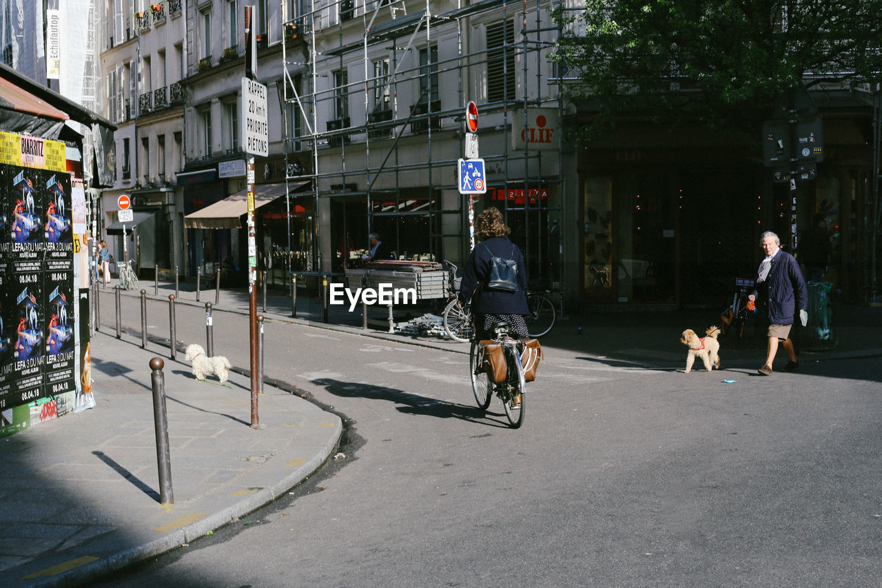 PEOPLE RIDING BICYCLE ON STREET