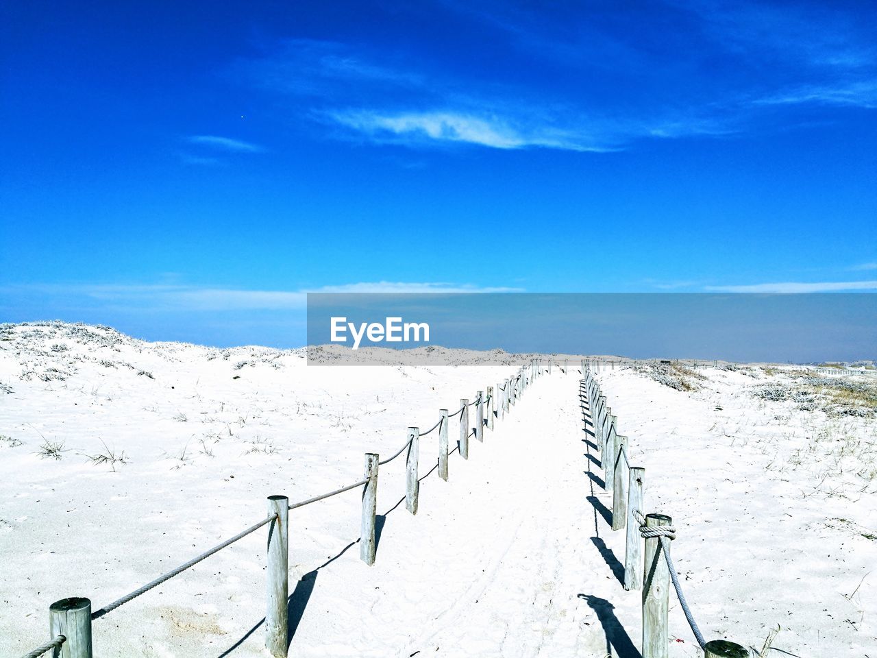 Scenic view of snowcapped mountains against blue sky