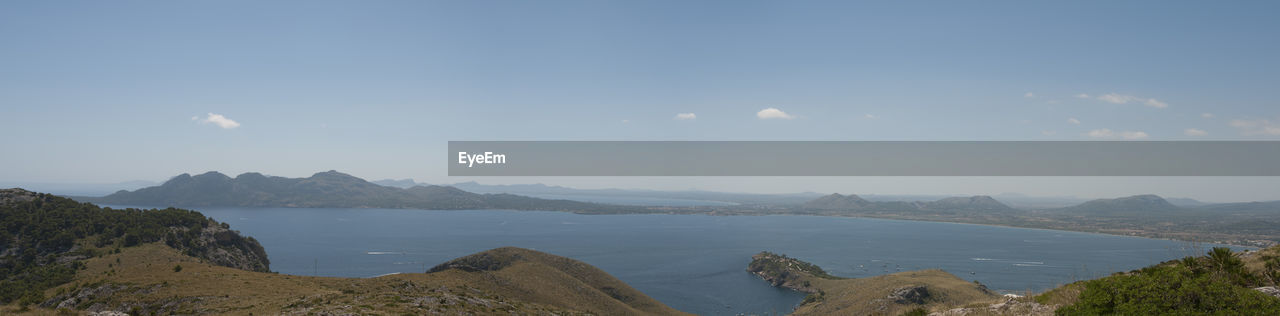 Panoramic view of sea and mountains against sky