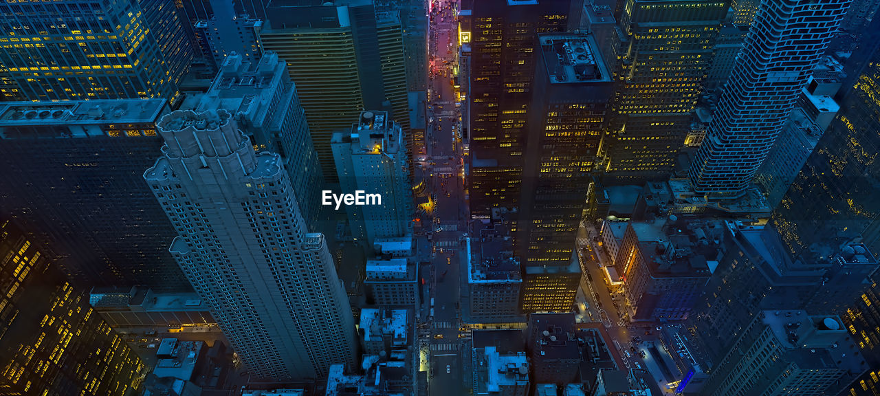 Aerial view of illuminated buildings in city at night,new york city