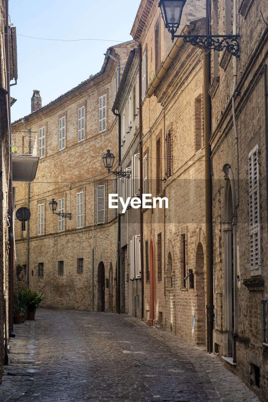 Narrow street amidst buildings in town