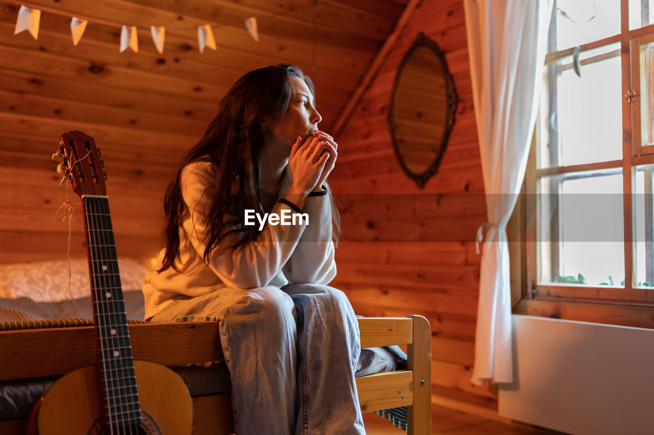 Frustrated confused asian young woman feeling anxious after reading bad news looking away at window