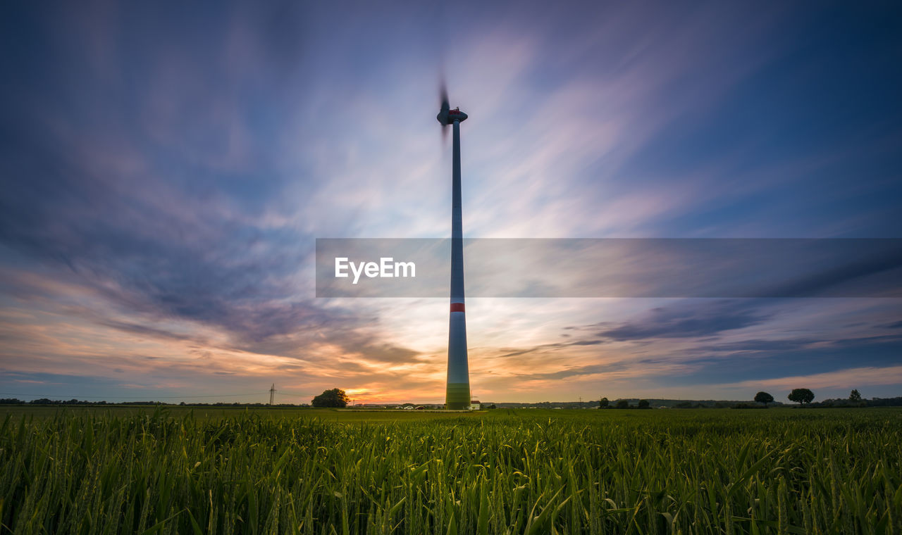 AGRICULTURAL FIELD AGAINST SKY DURING SUNSET