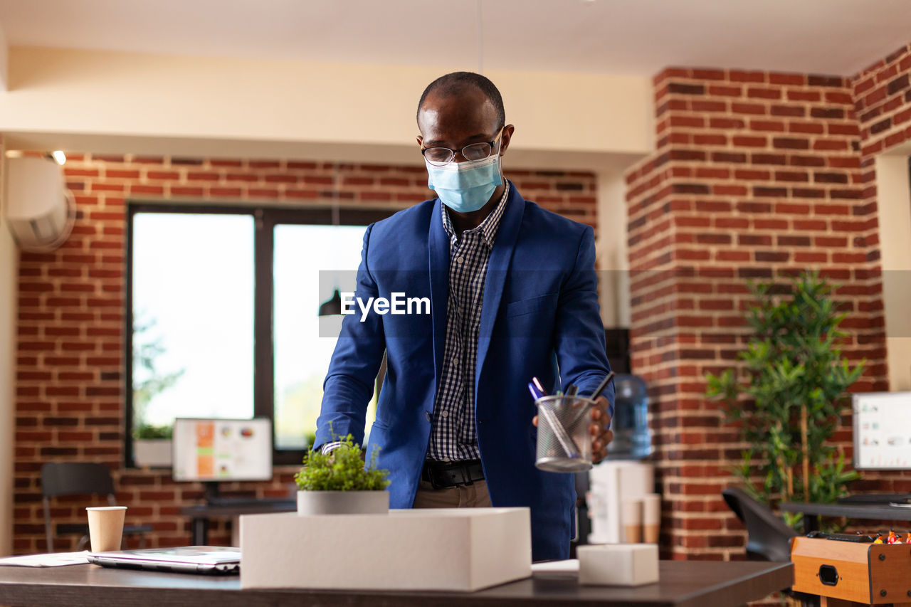 MAN STANDING ON TABLE