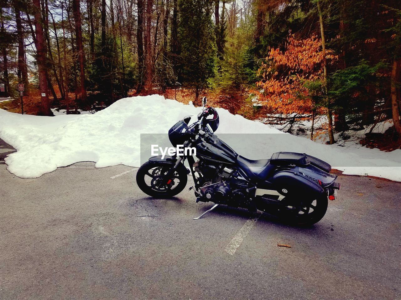 HIGH ANGLE VIEW OF PERSON RIDING MOTORCYCLE ON ROAD