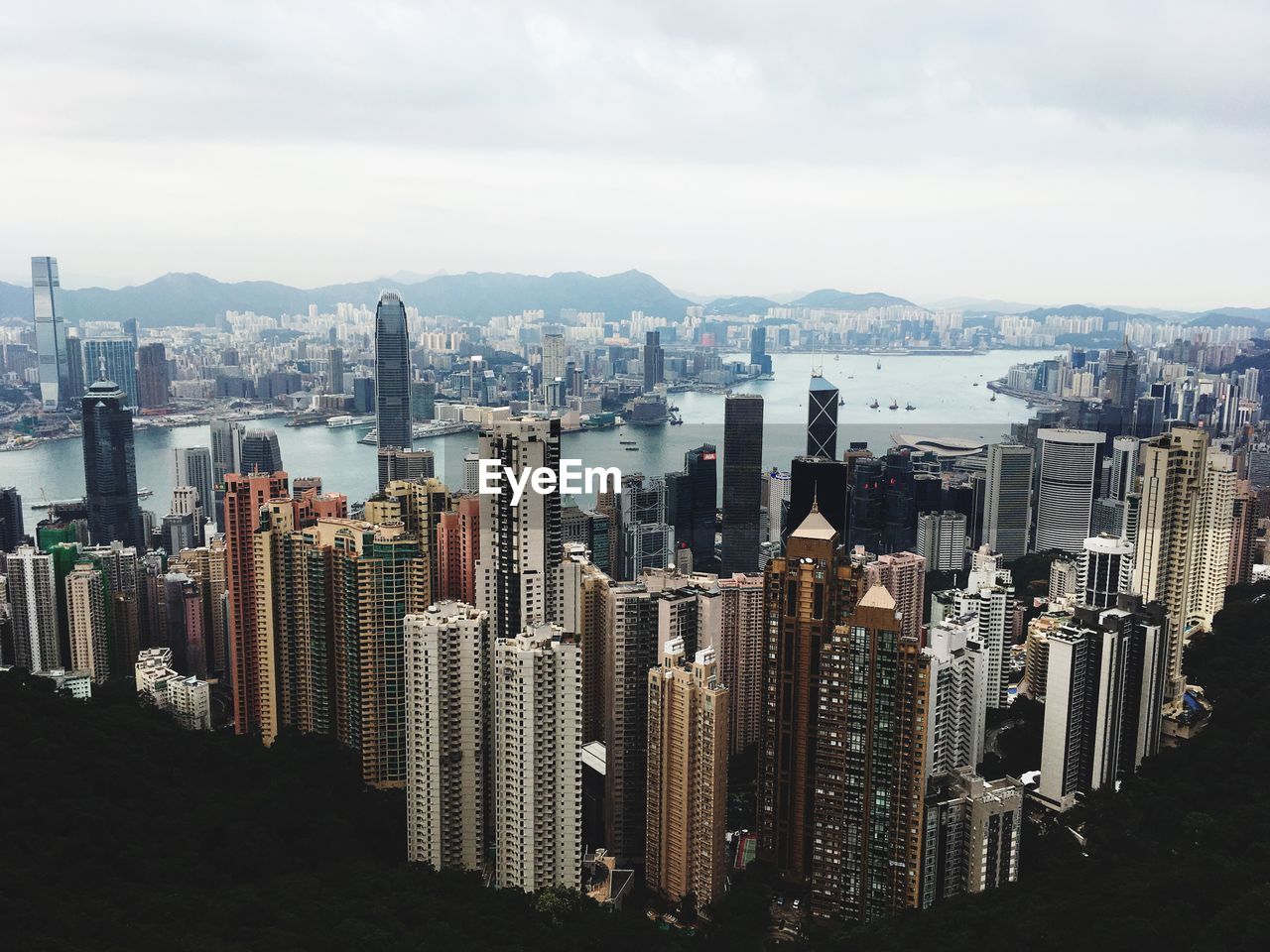 Aerial view of buildings in city against sky