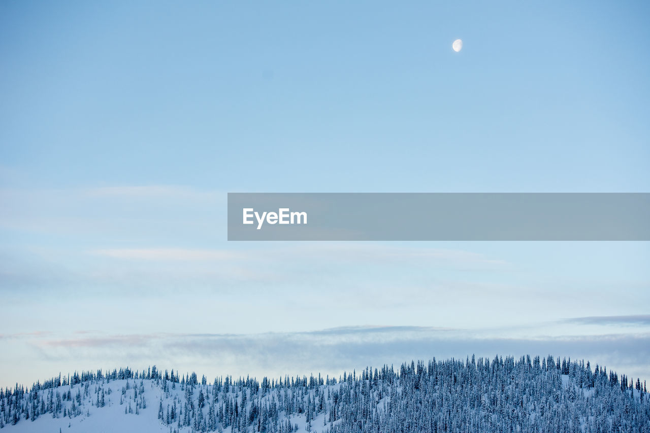 Beautiful moonrise over the snowy peaks.