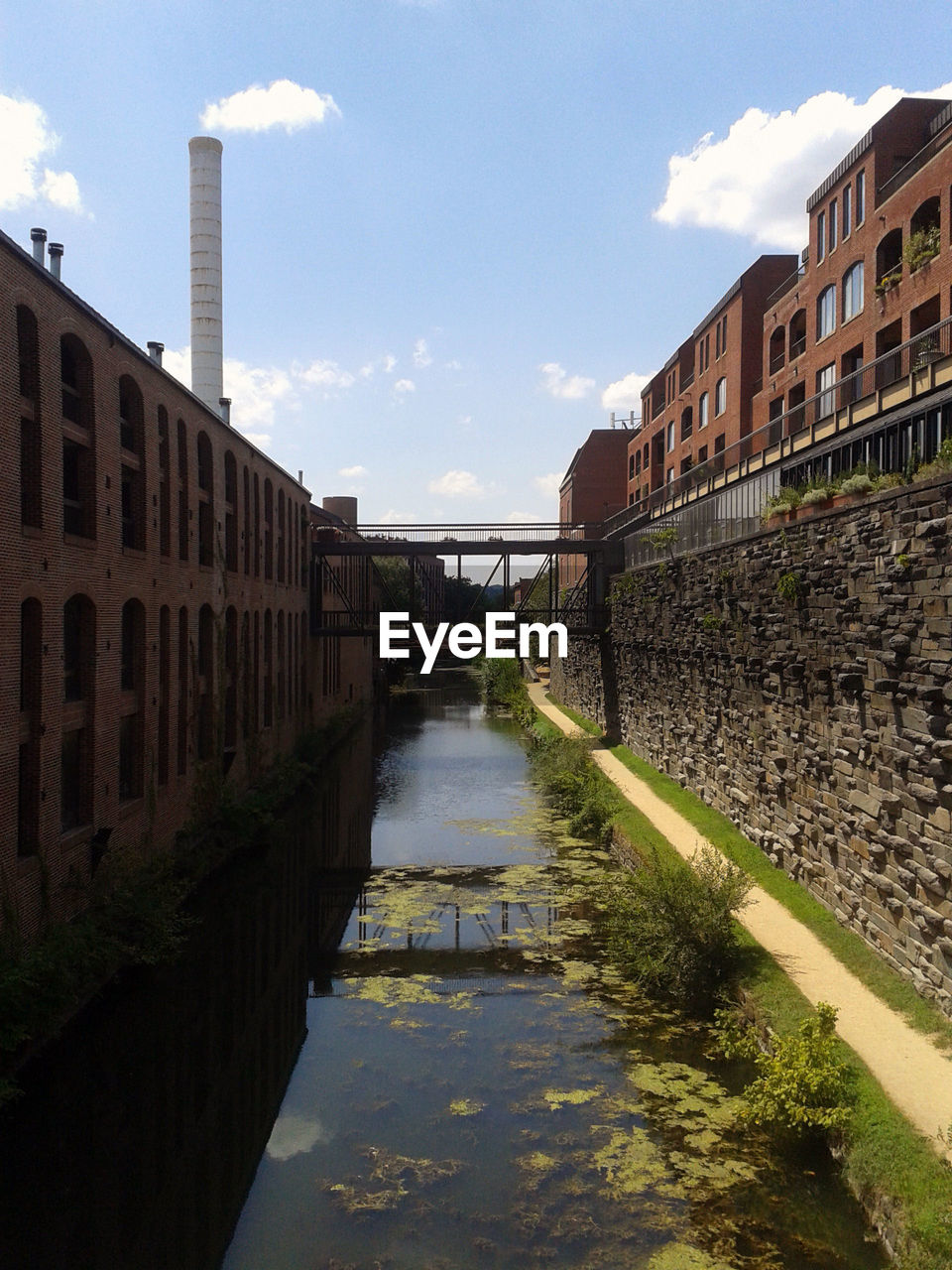 VIEW OF CITY BY WATER AGAINST SKY