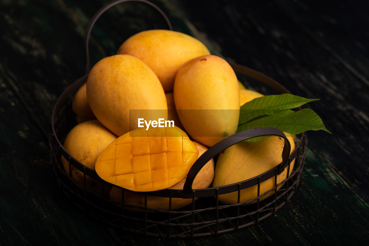 food and drink, food, yellow, healthy eating, freshness, fruit, plant, wellbeing, citrus, basket, citrus fruit, no people, macro photography, produce, wood, container, still life, indoors, nature, orange, clementine, leaf, high angle view, table, bowl, close-up, plant part, orange color, flower, organic