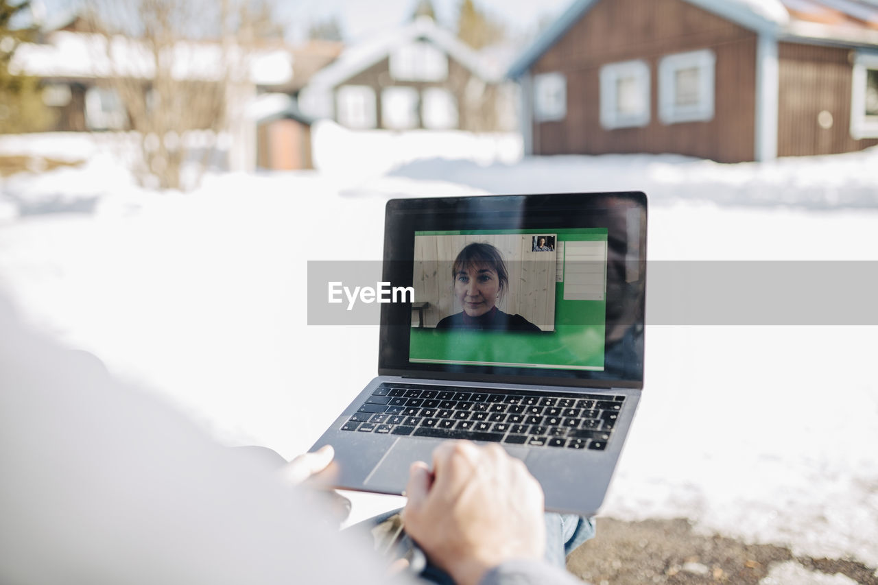 Male entrepreneur on video call through laptop with businesswoman