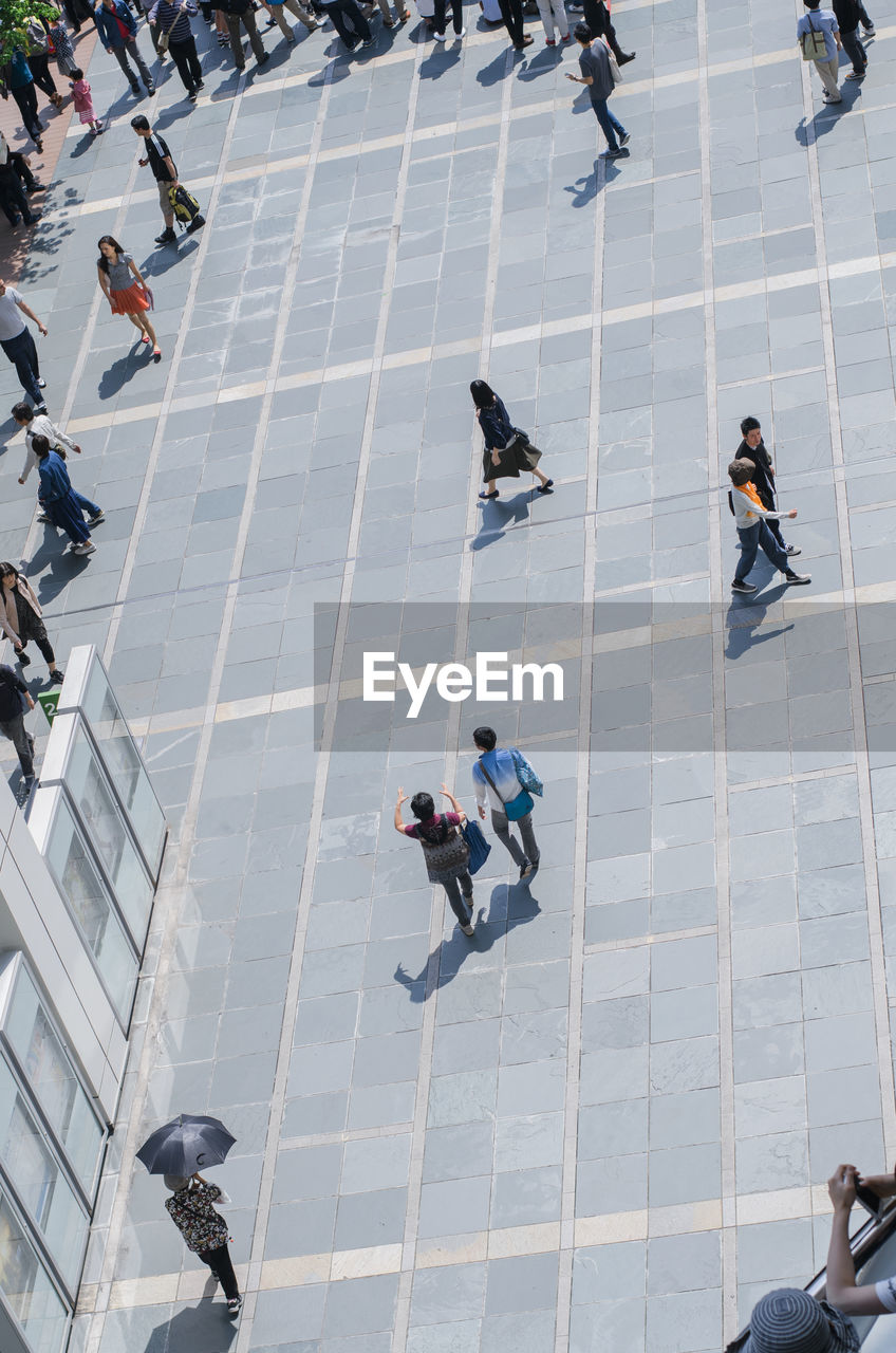 High angle view of people on footpath in city