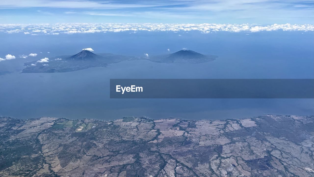 AERIAL VIEW OF SNOWCAPPED MOUNTAINS AND SEA