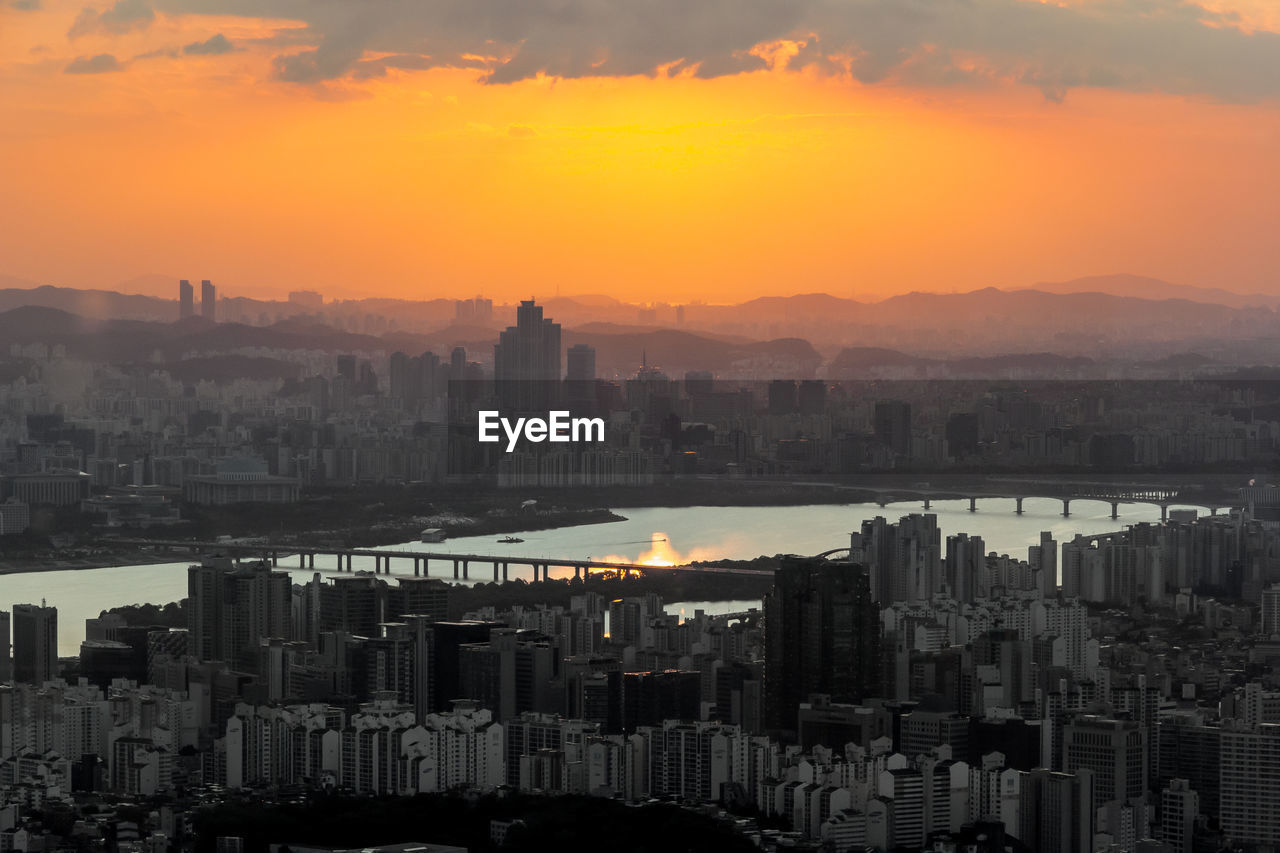 High angle view of seoul city and han river against sky during sunset