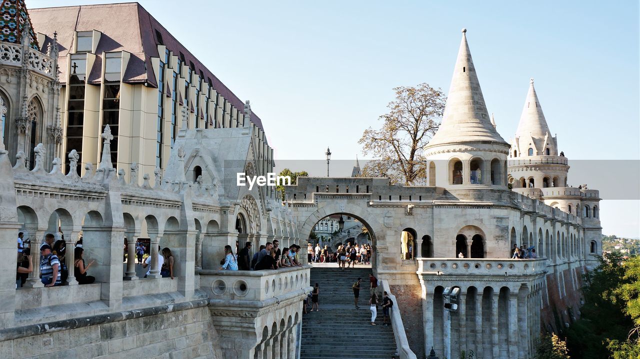 GROUP OF PEOPLE IN FRONT OF HISTORICAL BUILDING