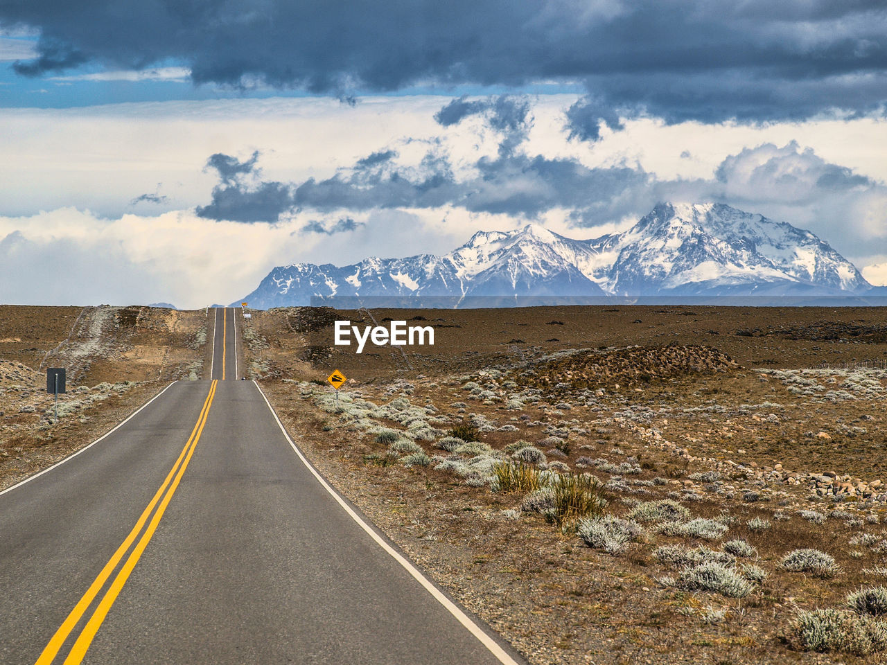 Country road passing towards mountains