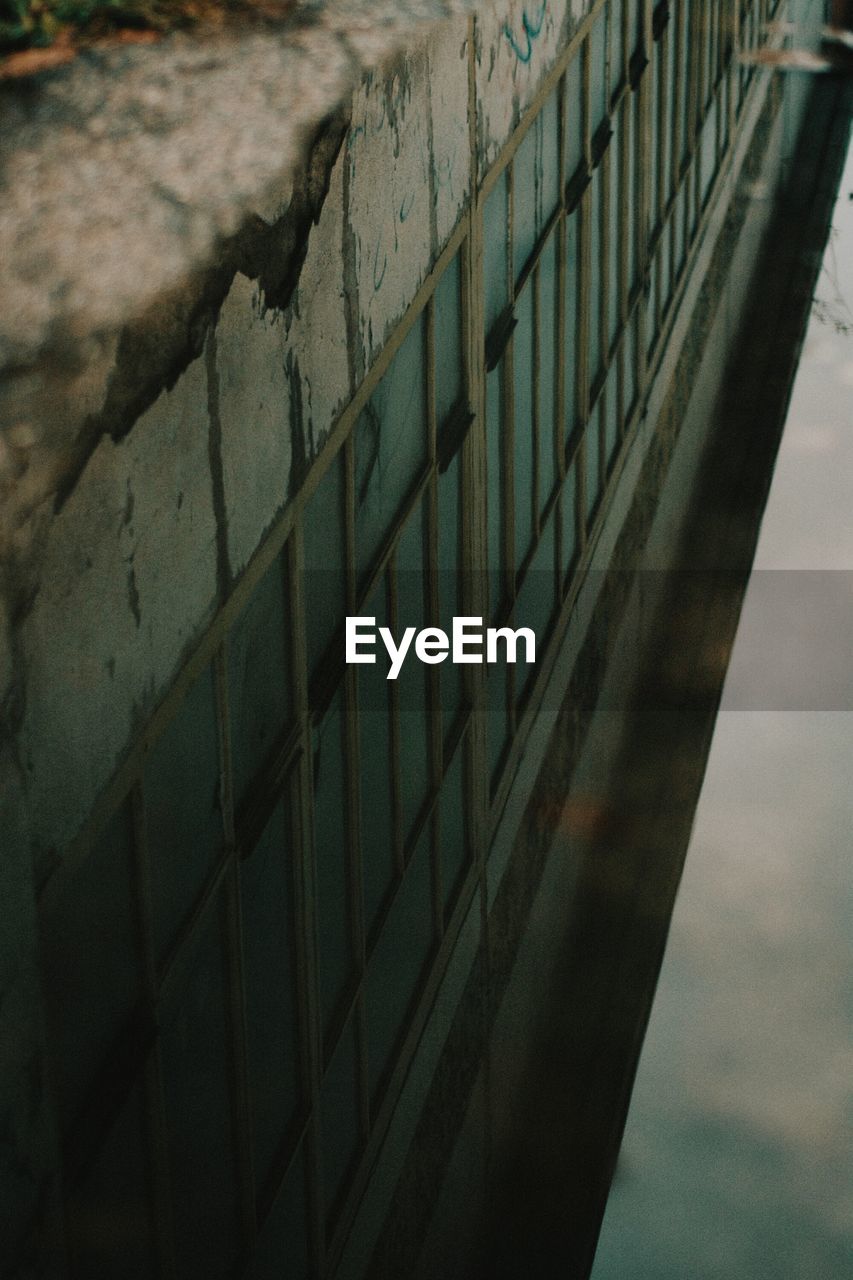 CLOSE-UP OF WATER REFLECTION ON BUILT STRUCTURE