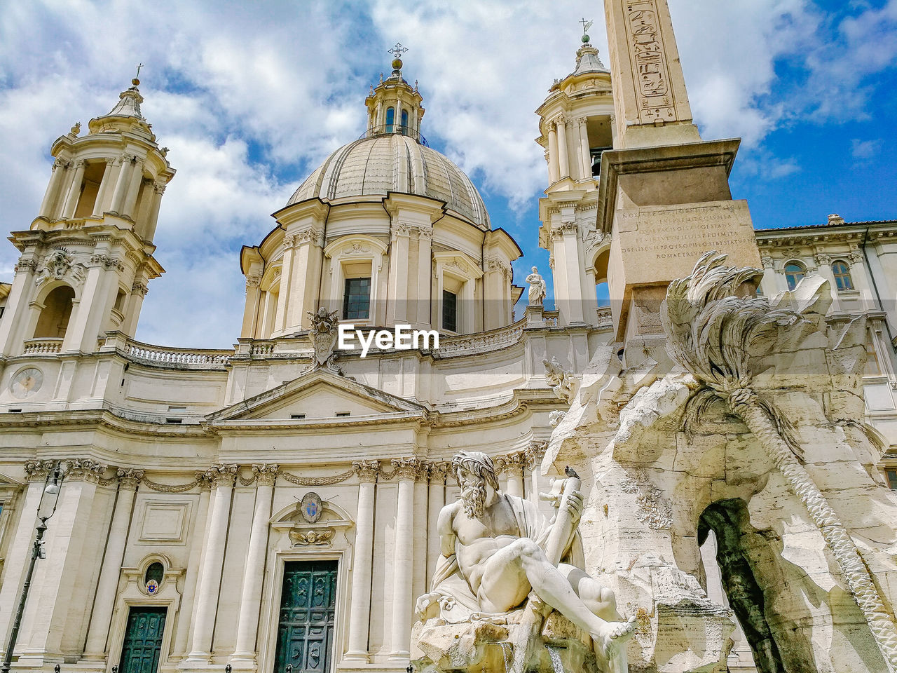 Low angle view of statues on building against sky