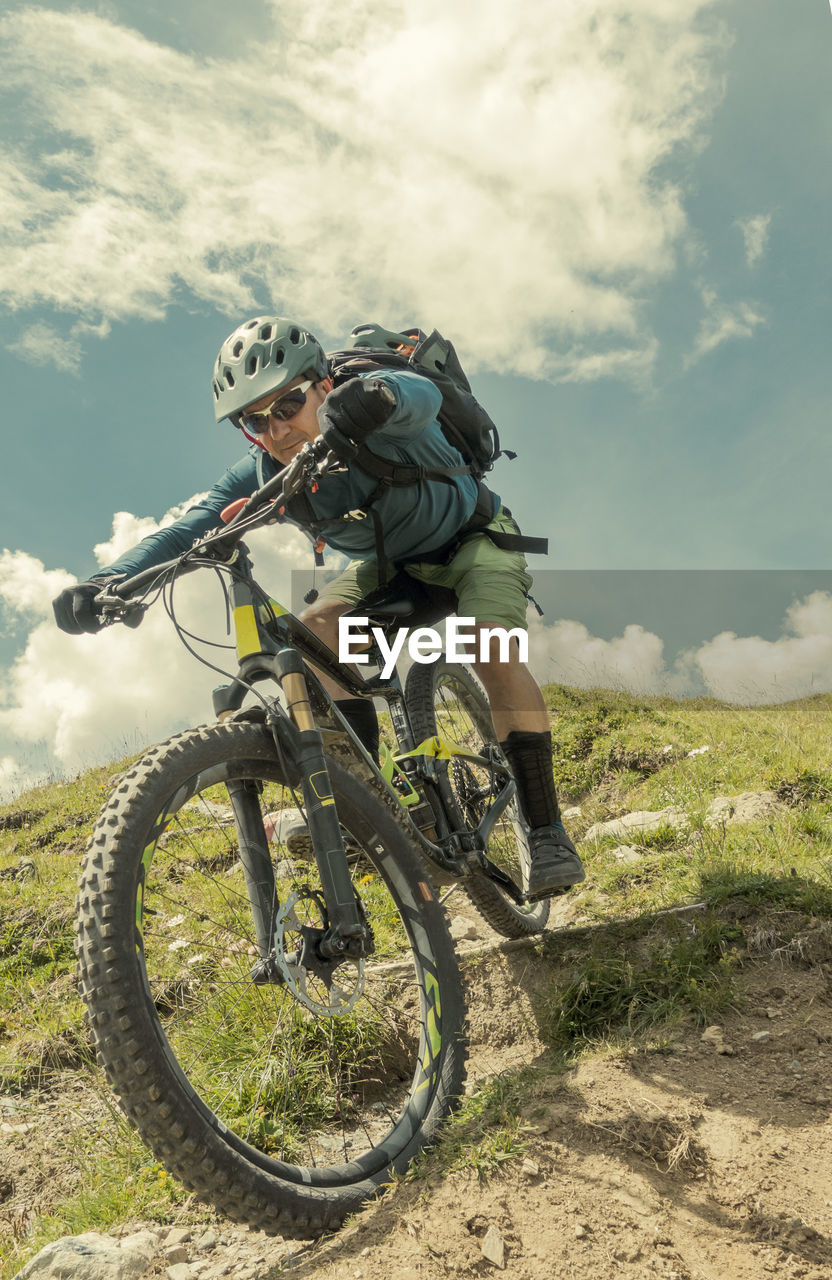 MAN RIDING BICYCLE