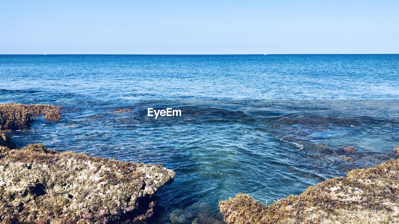 Scenic view of sea against clear sky