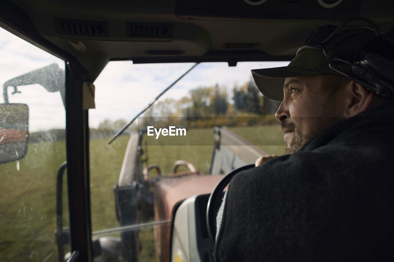 Farmer driving tractor