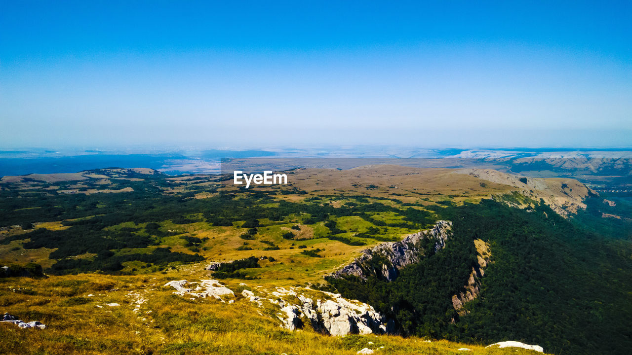 AERIAL VIEW OF LANDSCAPE AGAINST BLUE SKY