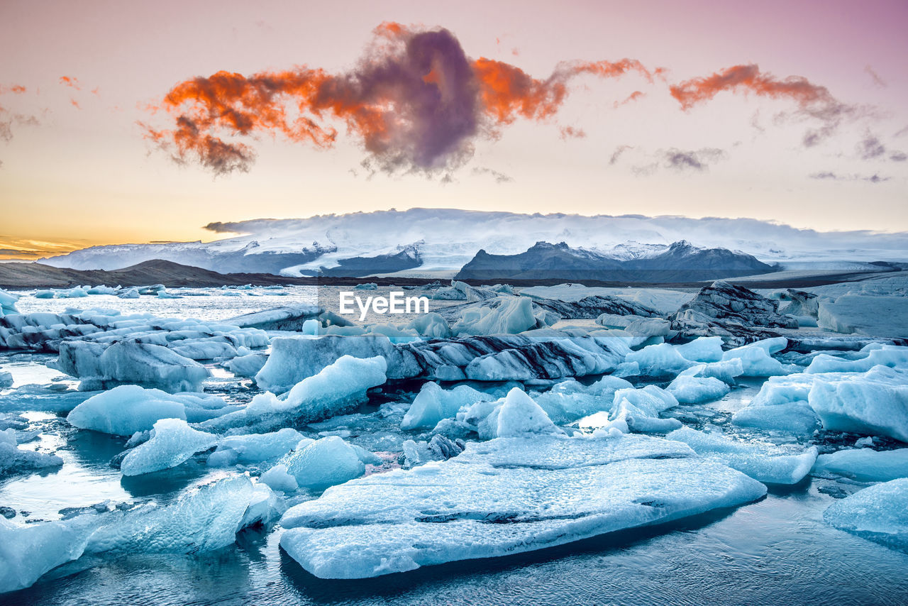 Scenic view of frozen landscape against sky during winter