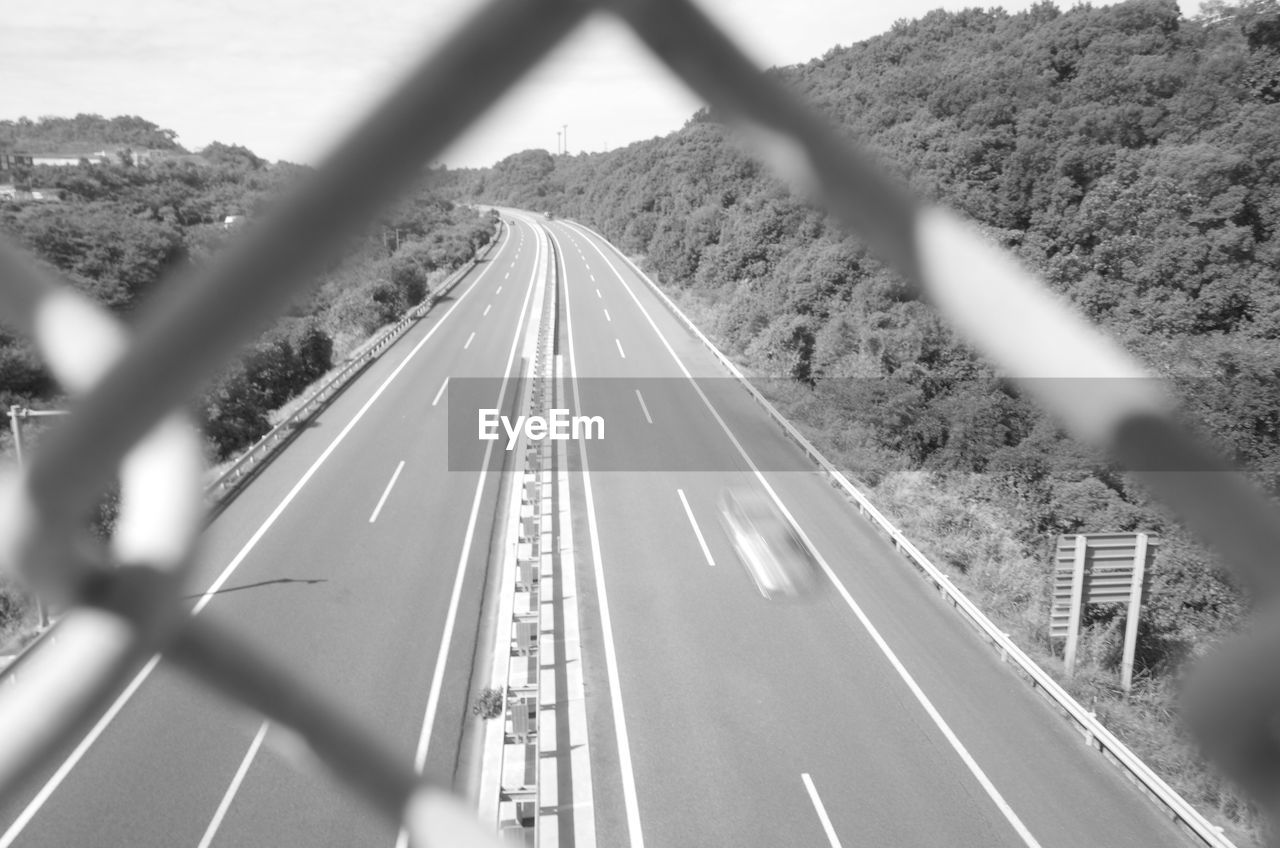 High angle view of highway seem through chainlink fence