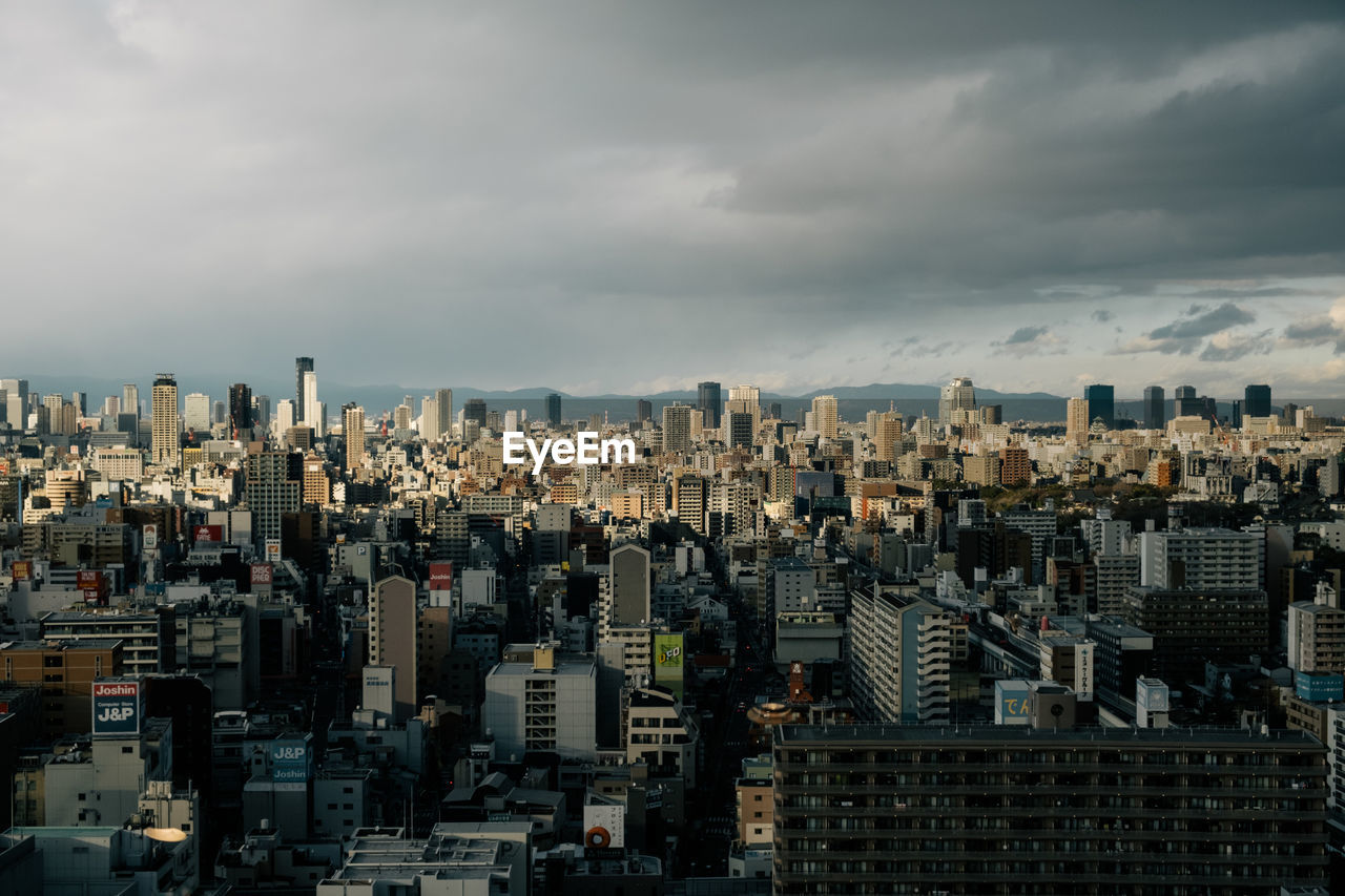 Aerial view of modern buildings in city against sky