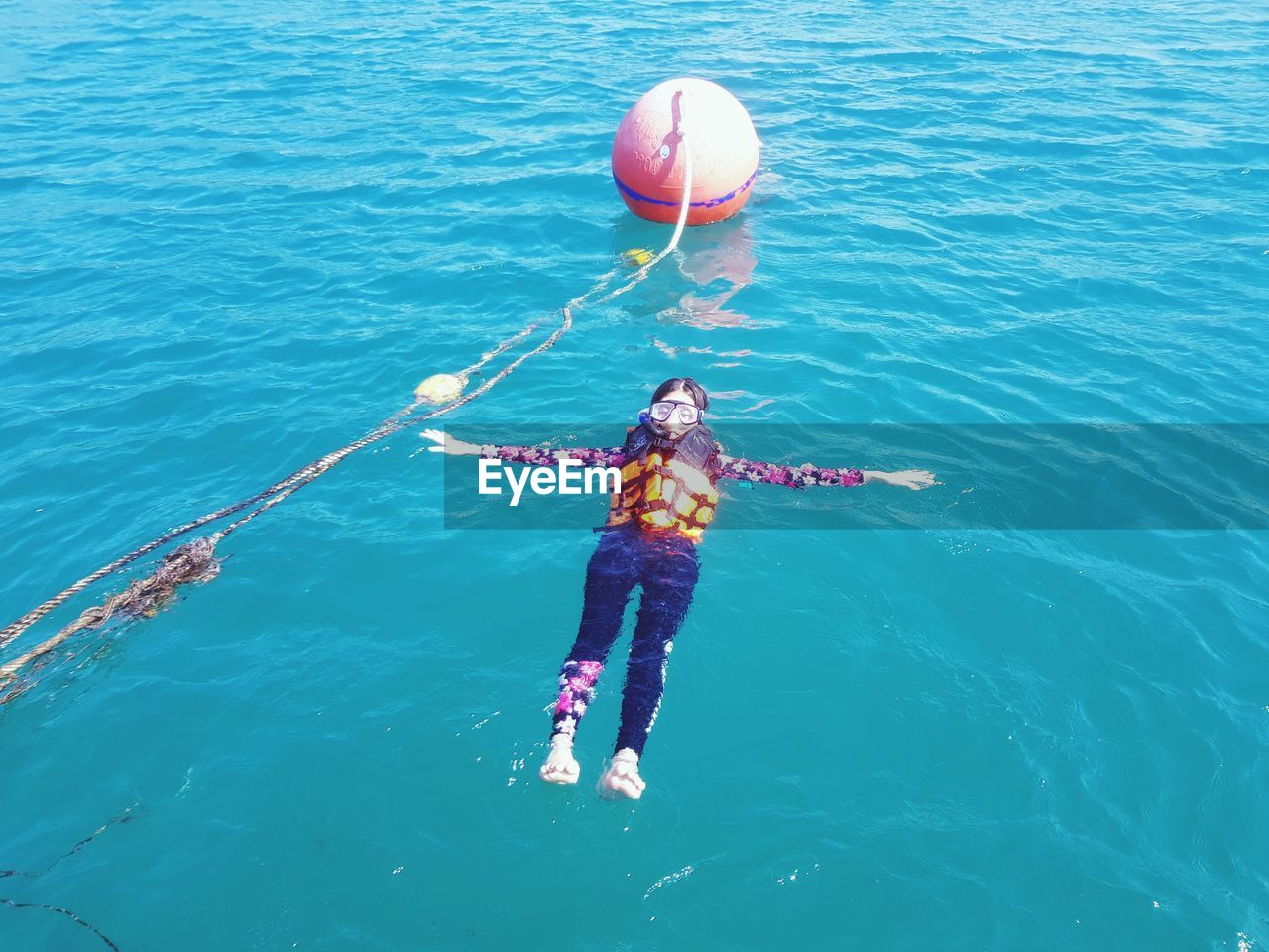 High angle view of woman swimming in sea