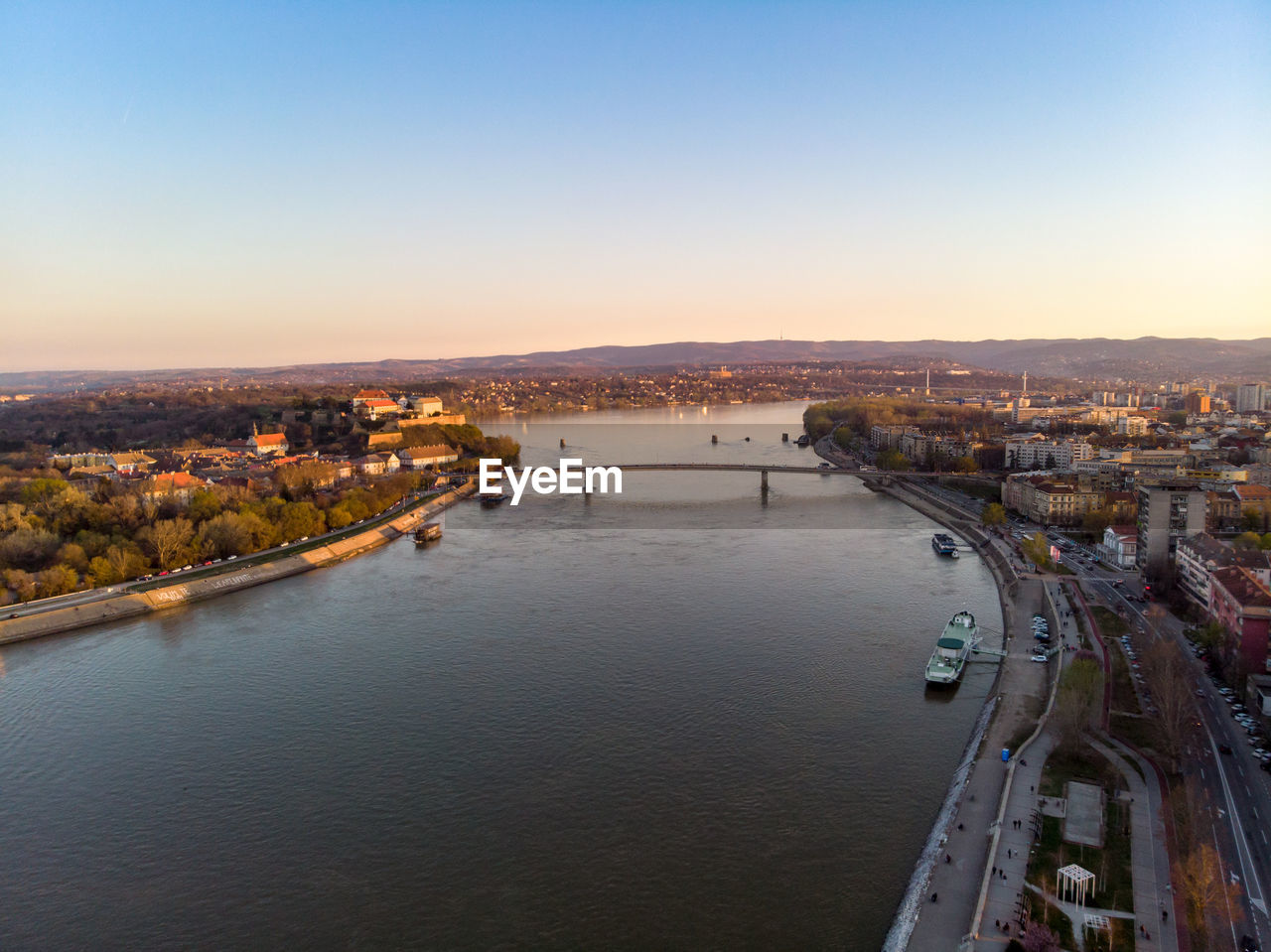 High angle view of river amidst buildings in city against sky