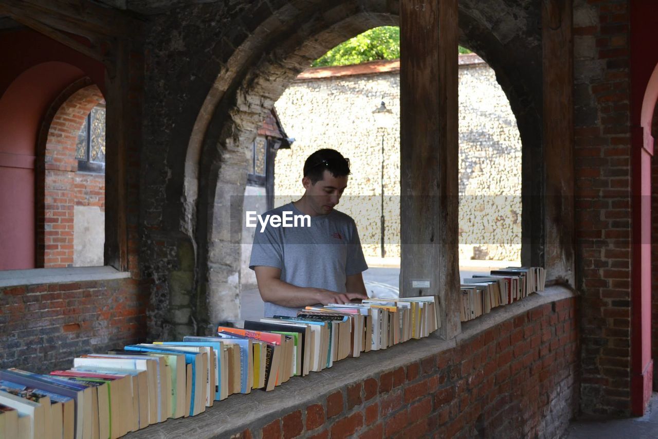 Man looking at books