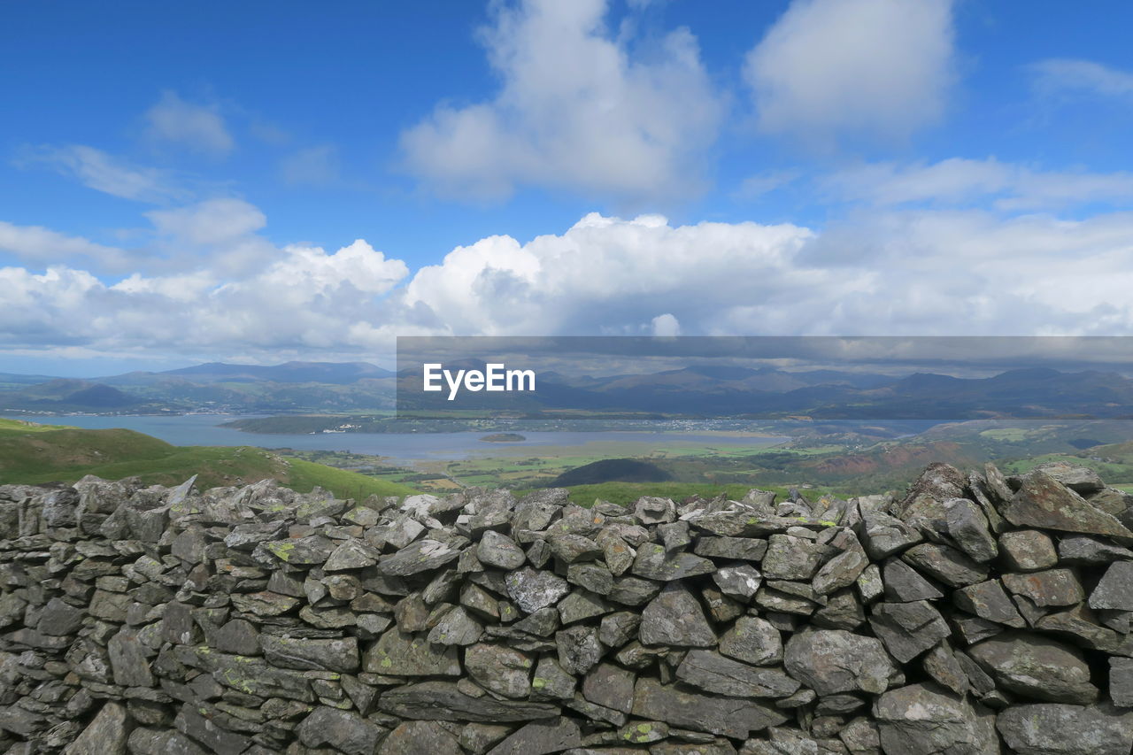 Stack of rocks on landscape against sky