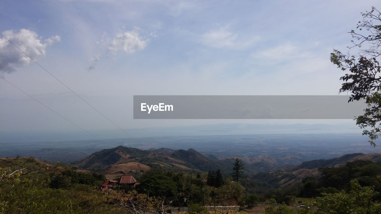 SCENIC VIEW OF LANDSCAPE AND MOUNTAINS AGAINST SKY