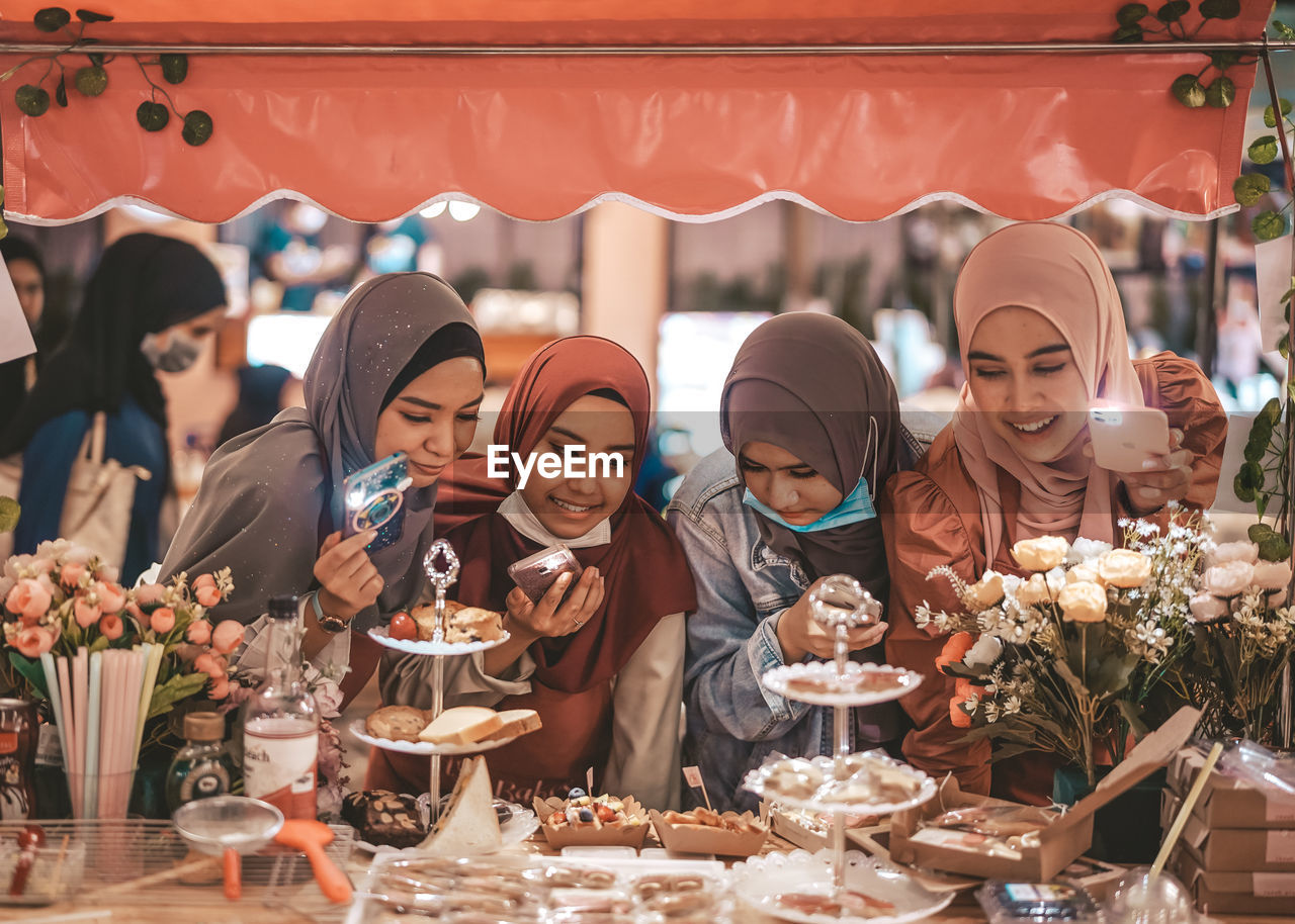 Group of people happy in choosing the dessert