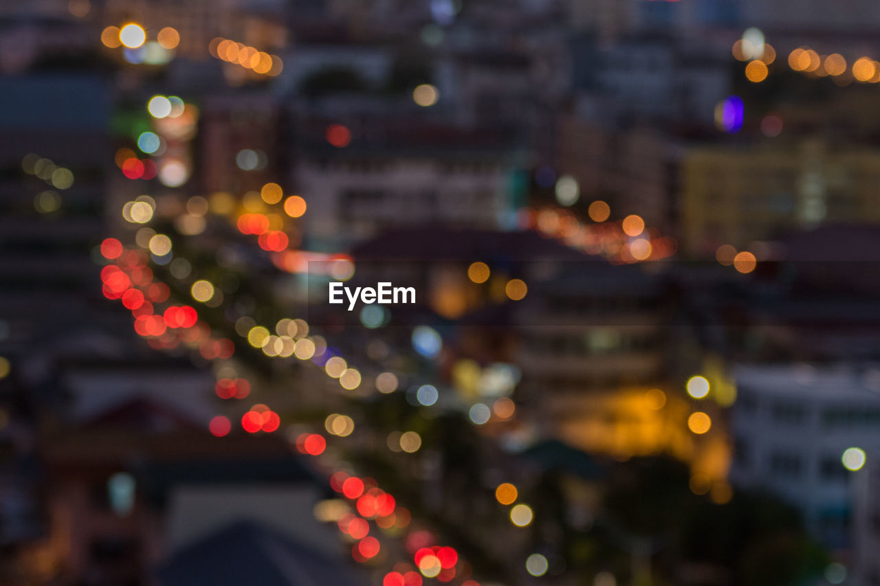 Defocused image of illuminated city at night