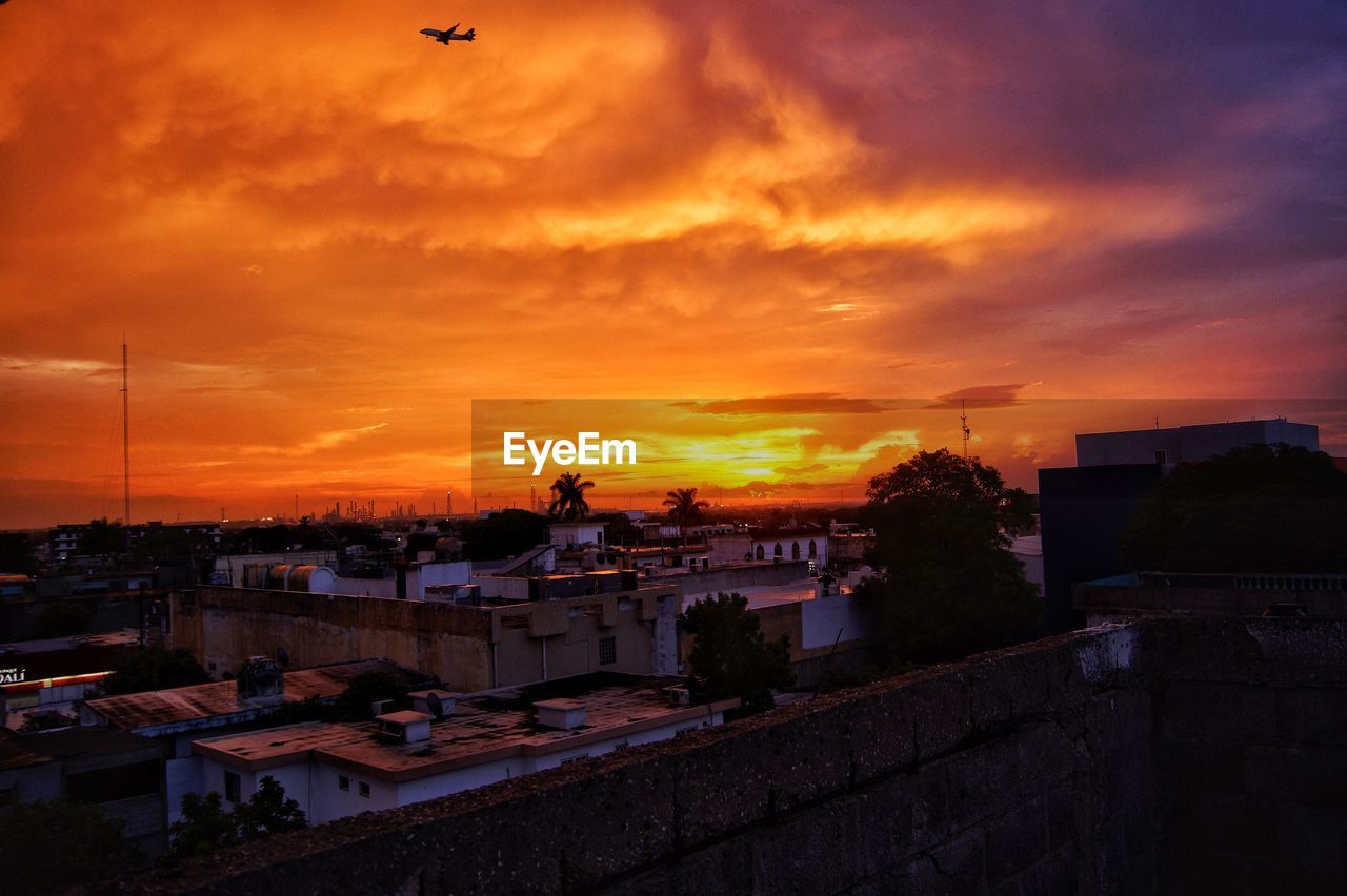High angle view of buildings against sky during sunset
