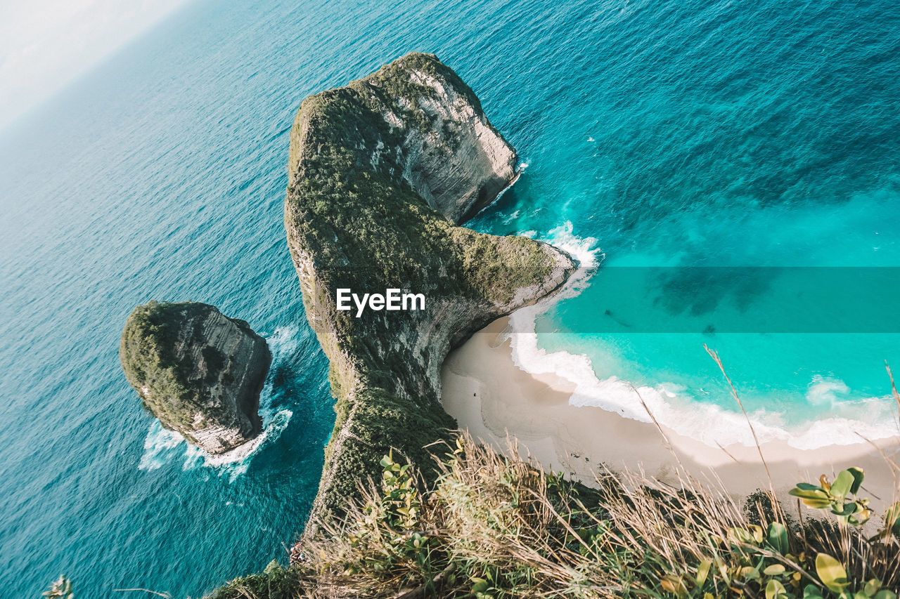 High angle view of rocks on sea shore