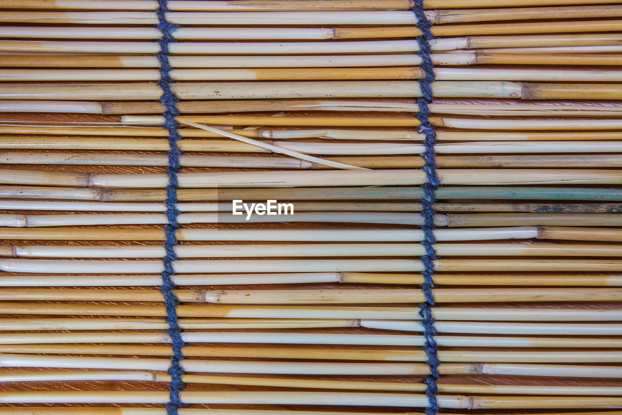 FULL FRAME SHOT OF WOOD STACK ON WOODEN FLOOR