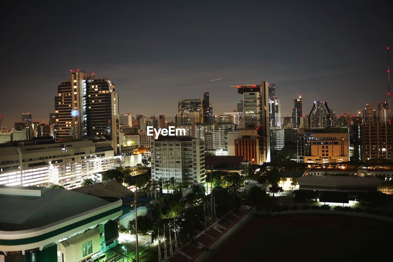 High angle view of illuminated buildings in city at night