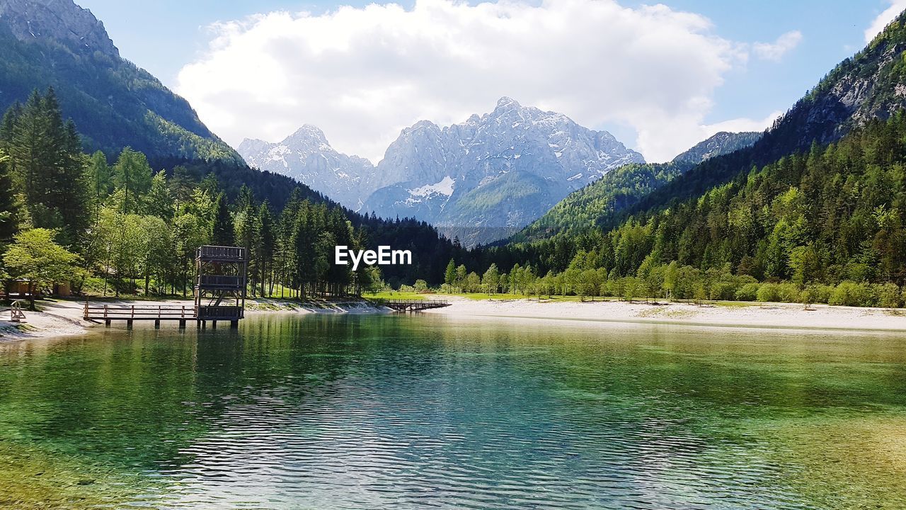 Scenic view of lake and mountains against sky