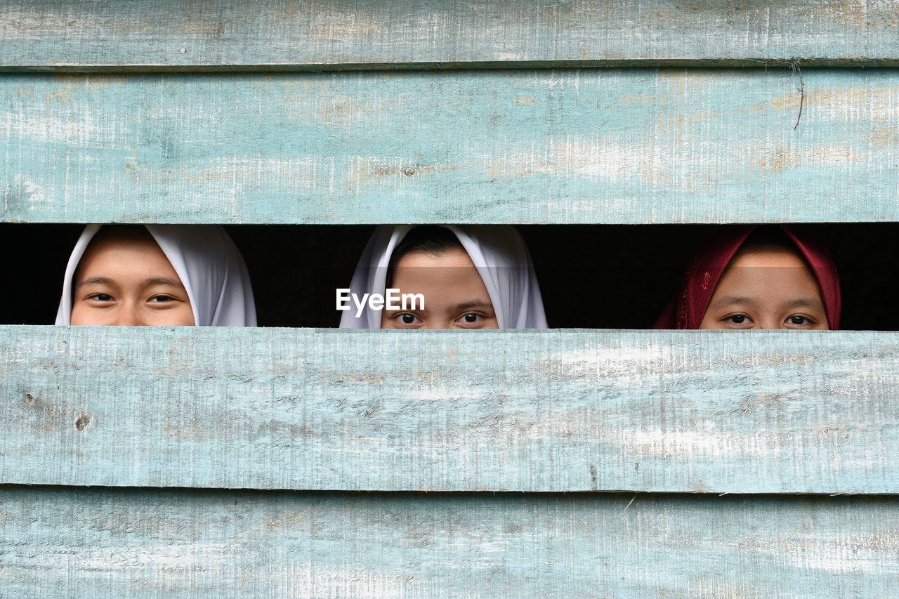 PORTRAIT OF A BEAUTIFUL YOUNG WOMAN COVERING FACE COVERED WITH EYES