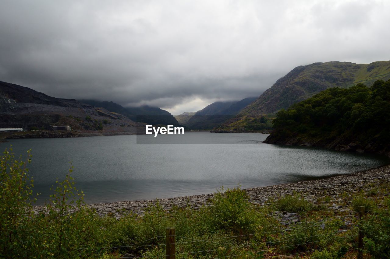 Scenic view of lake and mountains against sky