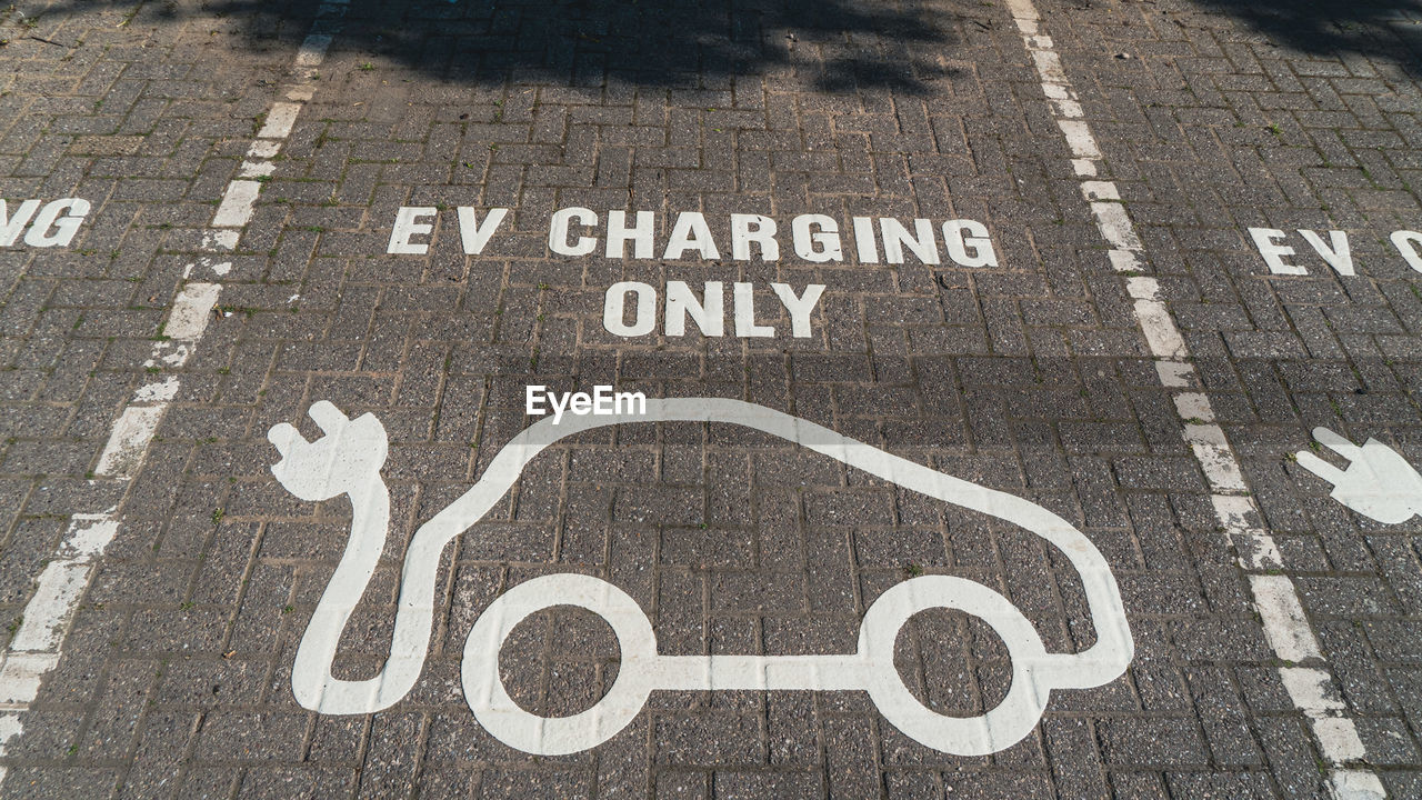 Ev charging parking space painted on car park surface