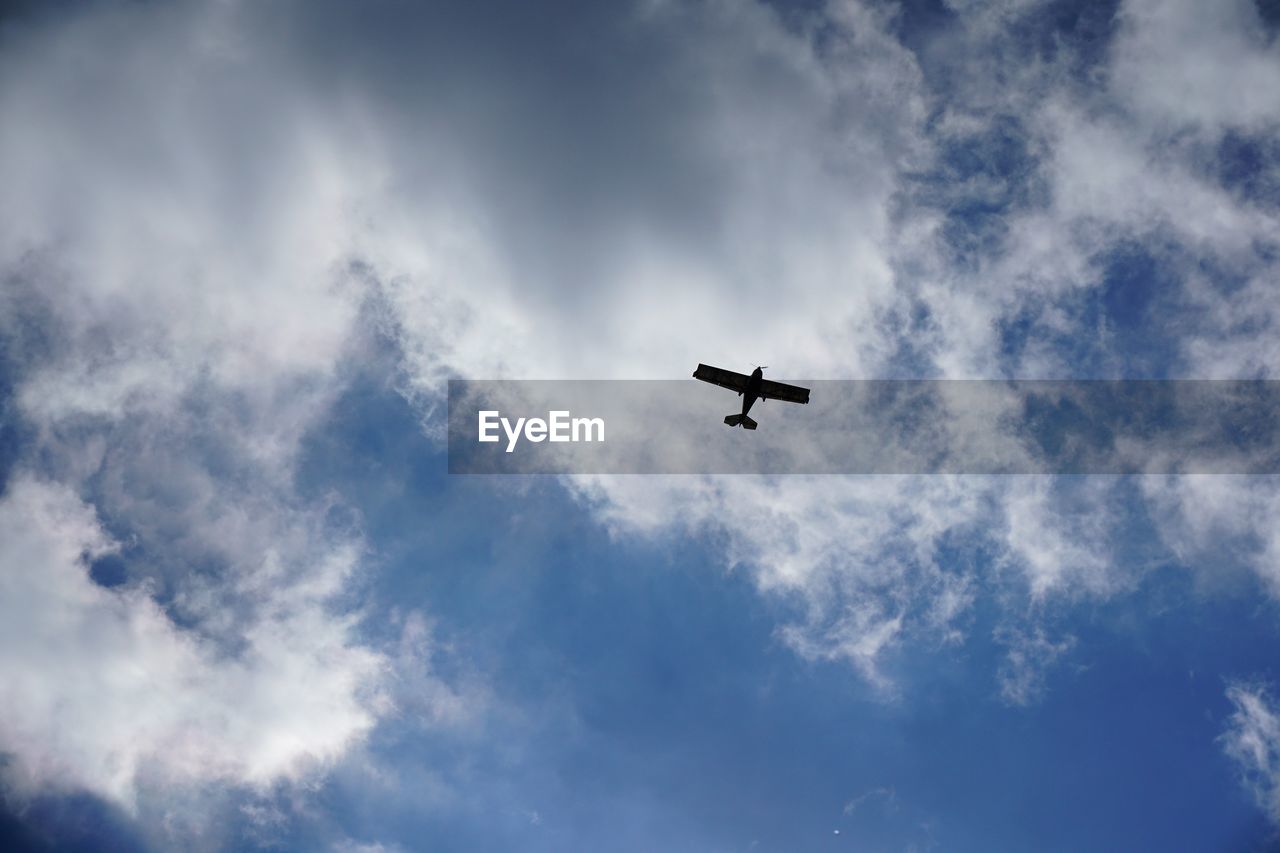 Low angle view of airplane in sky