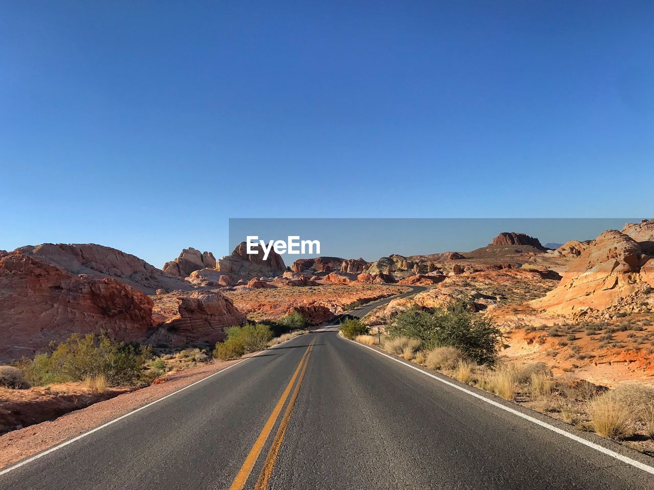 Road amidst landscape against clear sky