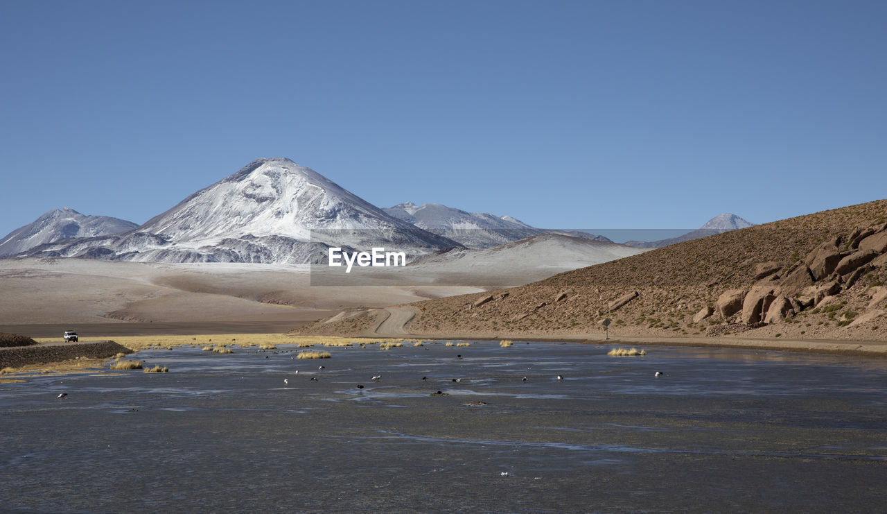 Highland lagoons next to geysers of "el tatio" at sunrise