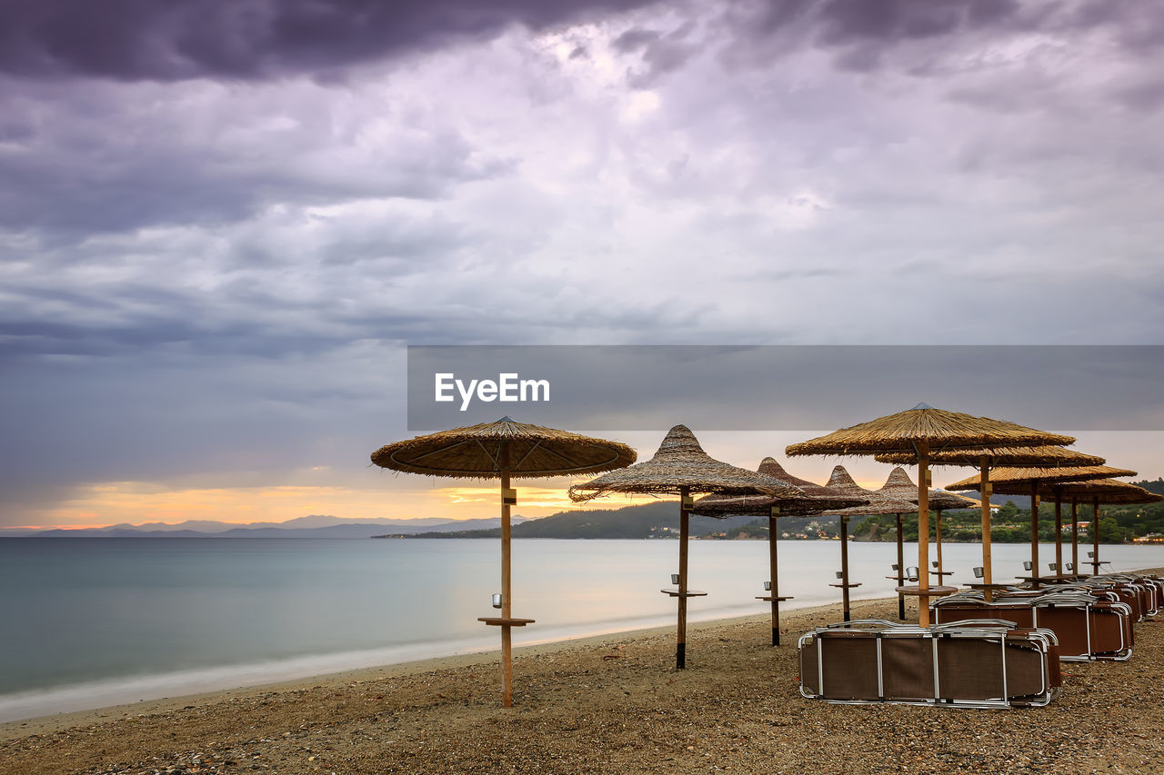 STILT HOUSE ON BEACH AGAINST SKY