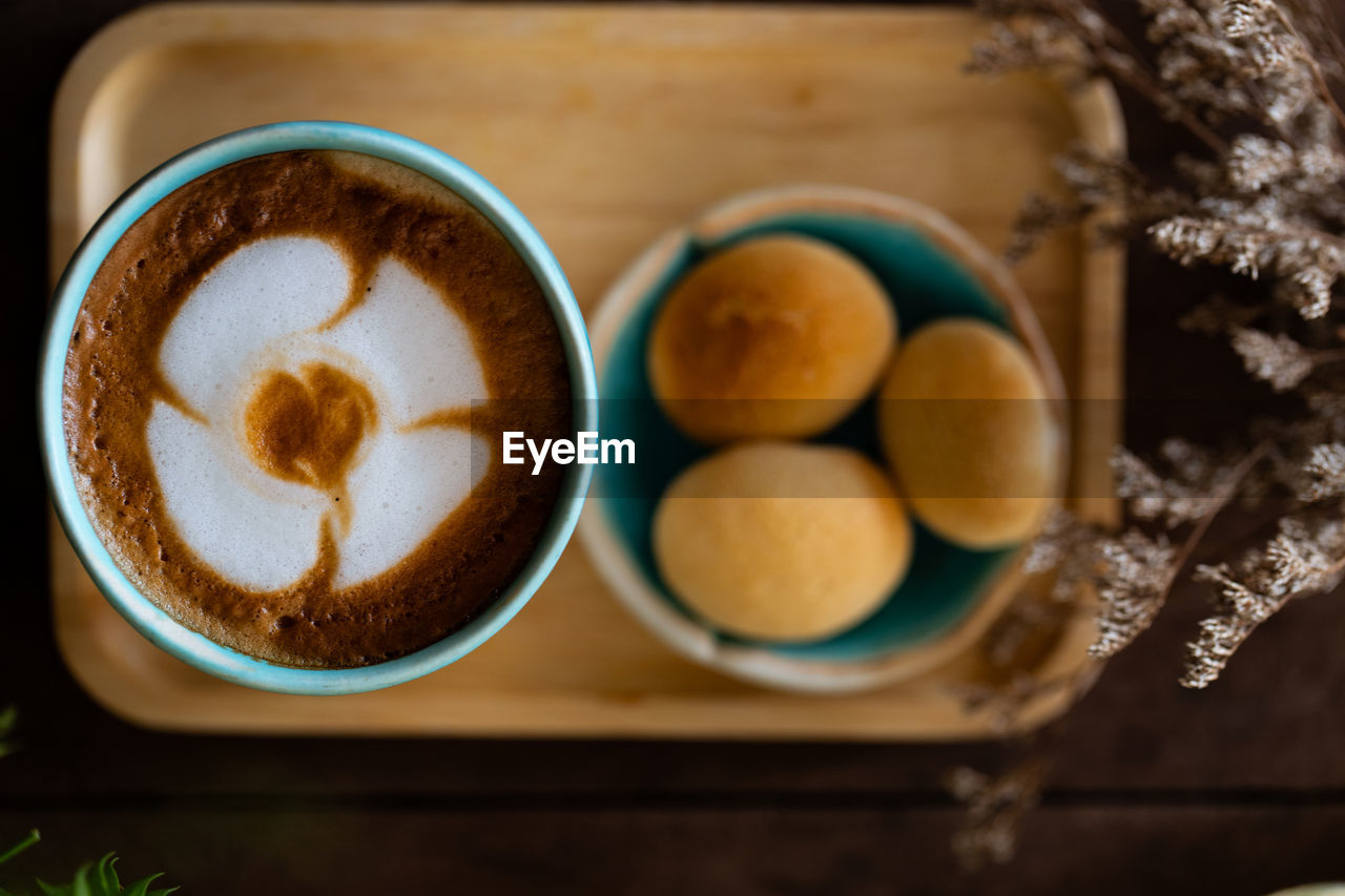 Directly above shot of coffee by cookies in tray