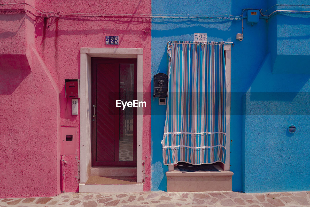 Pink and blue houses on sunny day