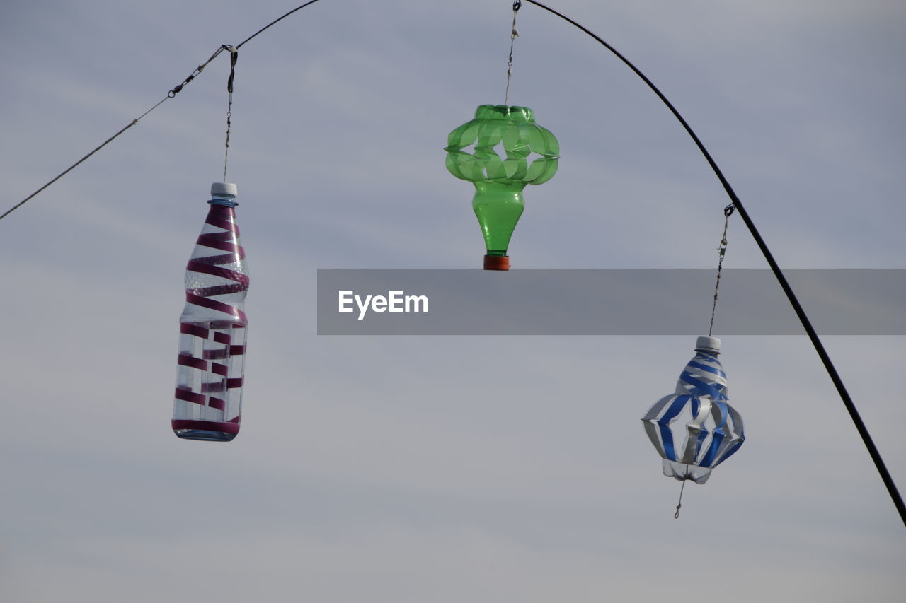 Low angle view of flags hanging against sky